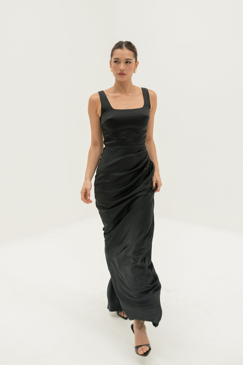 Woman wearing a black dress on a white background