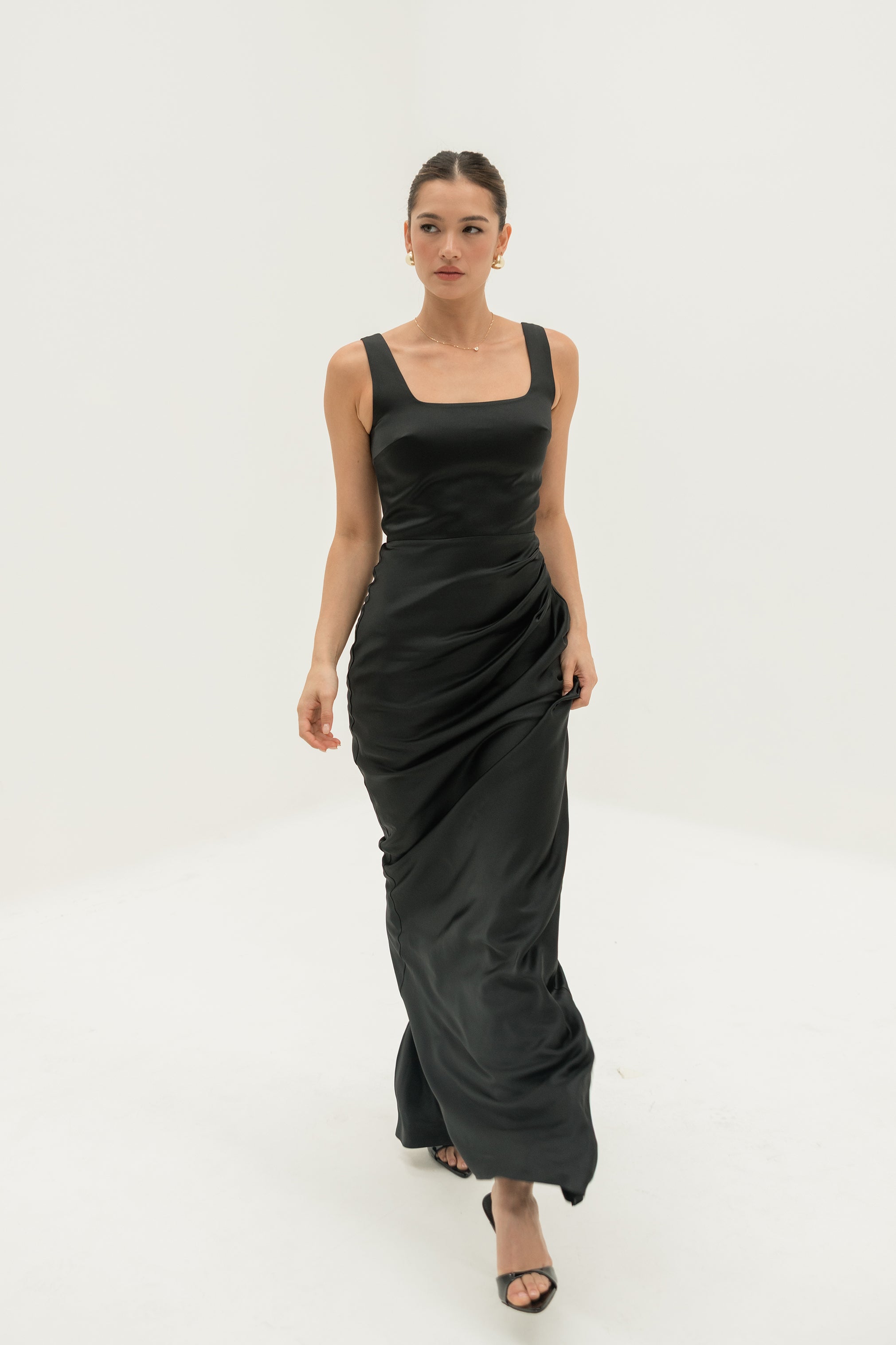 Woman wearing a black dress on a white background